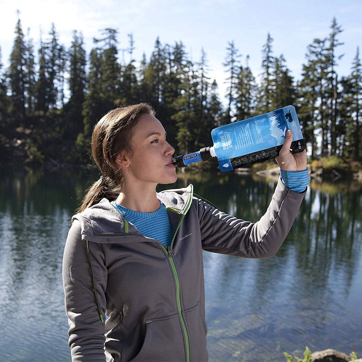 Sawyer mini woman drinking water in front of lake